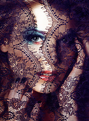 Image showing Portrait of beauty blond young woman through black lace close up