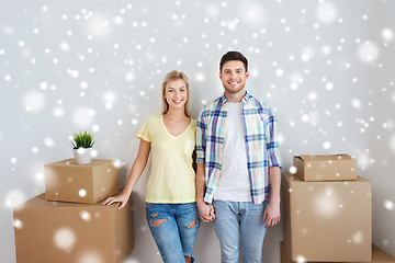 Image showing smiling couple with big boxes moving to new home