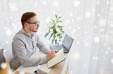 Image showing creative man or businessman writing to notebook