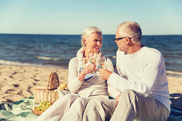 Image showing happy senior couple talking on summer beach