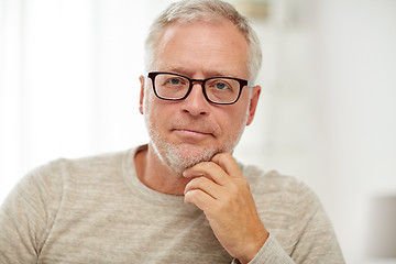 Image showing close up of senior man in glasses thinking