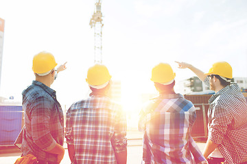 Image showing group of builders in hardhats at construction site