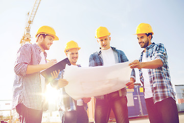 Image showing group of builders with tablet pc and blueprint