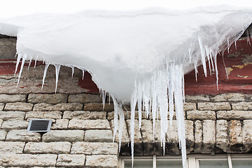 Image showing icicles and snow hanging from building roof