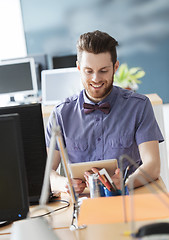 Image showing happy creative male office worker with tablet pc