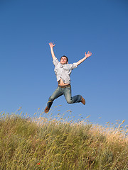 Image showing Happy Jumping Teenager Above Hill