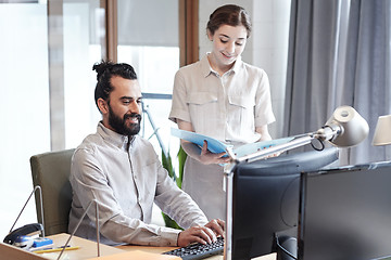 Image showing business team with computer and files in office