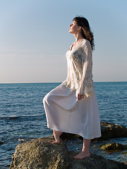 Image showing Young Woman on Sea Stone Looking Straight