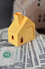 Image showing Miniature paper made house stand on  money