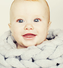 Image showing little cute red head baby in scarf all over him close up isolate