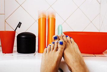 Image showing woman legs in bathroom with lot of stylish stuff for care, pedic