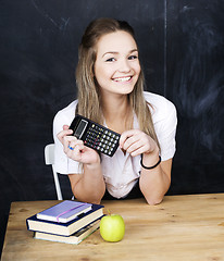 Image showing portrait of happy cute student with book in classroom