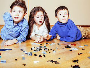 Image showing funny cute children playing lego at home, boys and girl smiling, first education role lifestyle