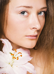 Image showing beauty young woman with lily close up, healthcare people concept