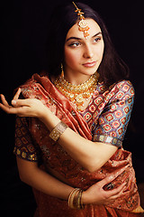 Image showing beauty sweet real indian girl in sari smiling on black background, lifestyle people concept