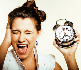 Image showing young beauty woman in business style costume waking up for work early morning on white background with clock