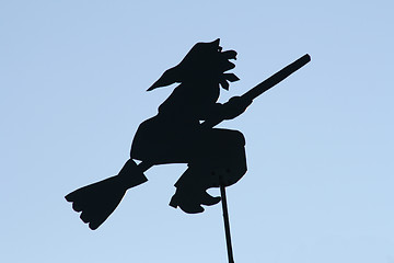 Image showing Black witch on the roof.