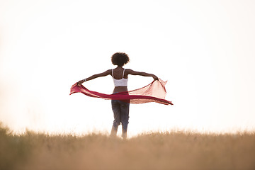 Image showing black girl dances outdoors in a meadow