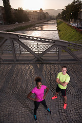 Image showing portrait of a young multiethnic couple jogging in the city