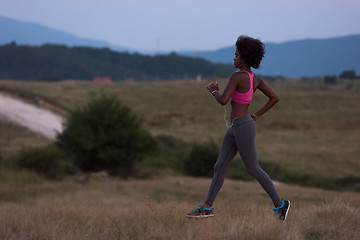 Image showing Young African american woman jogging in nature