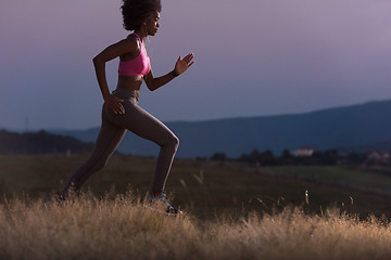 Image showing Young African american woman jogging in nature