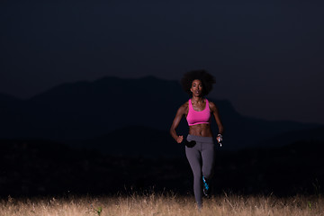 Image showing Young African american woman jogging in nature