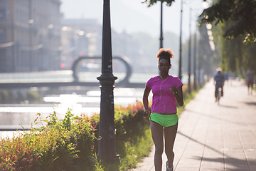 Image showing african american woman jogging in the city