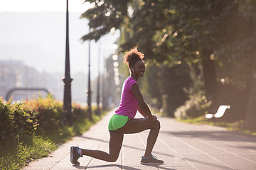 Image showing Black woman doing warming up and stretching