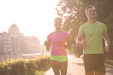 Image showing young multiethnic couple jogging in the city