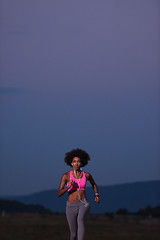 Image showing Young African american woman jogging in nature