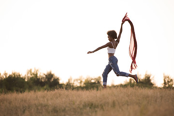 Image showing black girl dances outdoors in a meadow