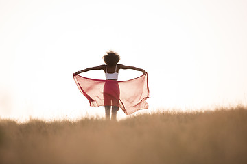 Image showing black girl dances outdoors in a meadow