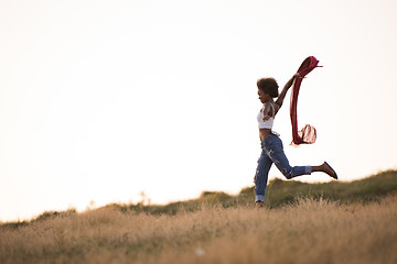 Image showing black girl dances outdoors in a meadow