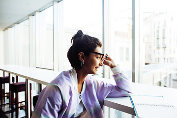 Image showing young cute hipster girl student sitting in cafe with notebook re