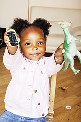 Image showing little cute african american girl playing with animal toys at ho