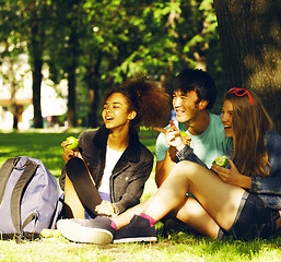 Image showing cute group of teenages at the building of university with books 