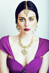 Image showing young pretty caucasian woman like indian in ethnic jewelry close up on white, bridal makeup