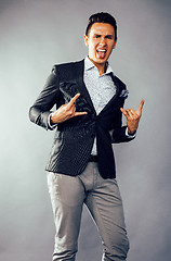 Image showing young pretty business man standing on white background, modern hairstyle, posing emotional, lifestyle people concept