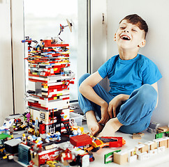 Image showing little cute preschooler boy playing with toys at home happy smiling kid, lifestyle people concept