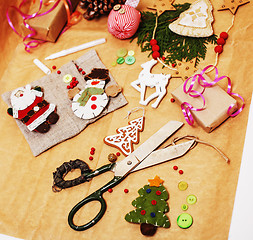 Image showing handmade christmas gifts in mess with toys, candles, fir, ribbon wooden vintage