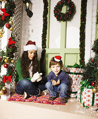 Image showing happy smiling family on Christmas at house with gifts, young mot