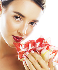 Image showing young pretty brunette woman with red flower amaryllis close up i