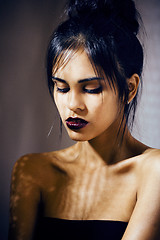 Image showing beauty latin young woman in depression, hopelessness look, fashion make up dark style