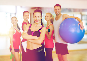 Image showing woman standing in front of the group in gym