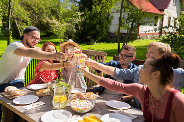 Image showing happy friends having dinner at summer garden party