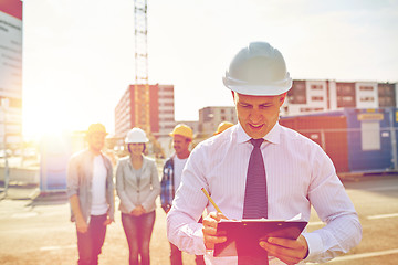 Image showing happy builders and architect at construction site