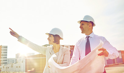 Image showing happy architects with blueprint at building