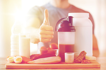 Image showing man with protein food showing thumbs up