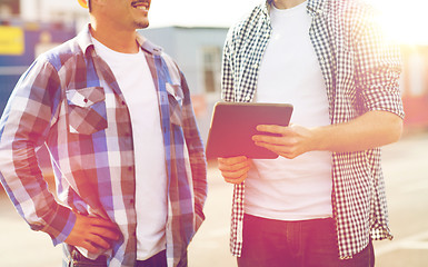 Image showing close up of builders with tablet pc outdoors