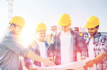 Image showing group of builders with tablet pc and blueprint